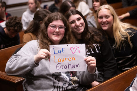Students hold up a sign that reads Laf Loves Lauren Graham.