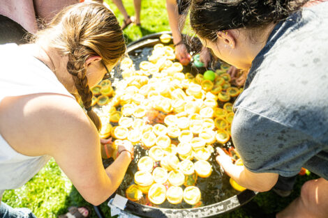 Students fill water balloons.