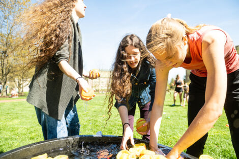 Students throw water balloons at each other.