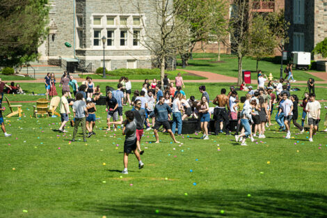 Students throw water balloons at each other.