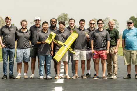 Students hold a model airplane
