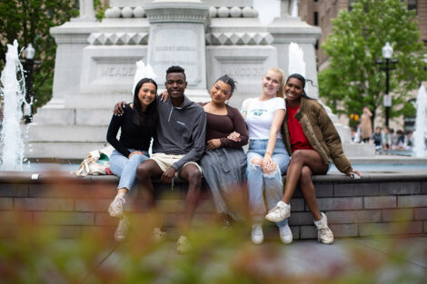 Students smile at the fountain at Centre Square.