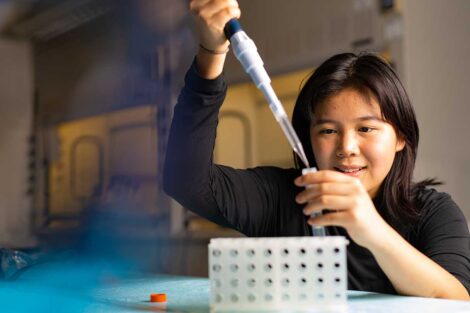 A student with lab equipment