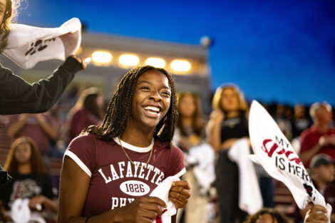 A student cheers during a football game