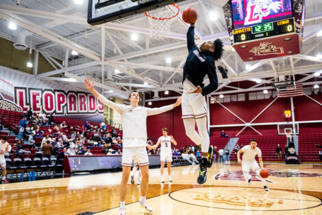 A basketball player goes up for a dunk