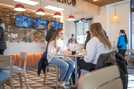 Two students enjoy lunch at Cinco restaurant.