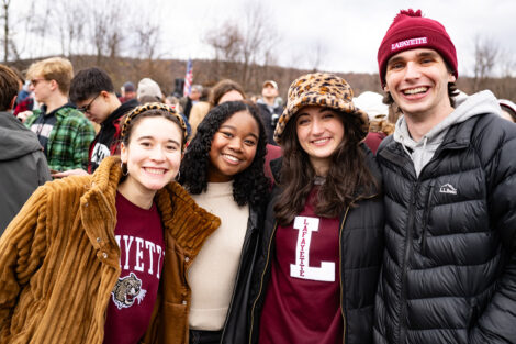 Four students in Lafayette and Leopard gear at a game