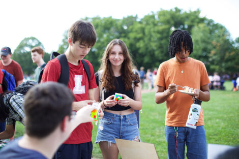 Students smile with rubix cubes